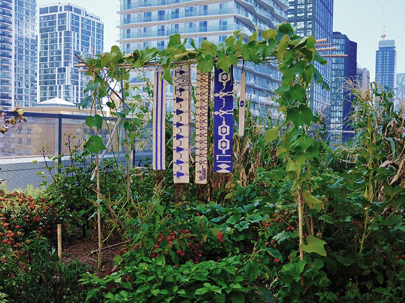 Indigenous wampum belts hanging in a rooftop garden. 