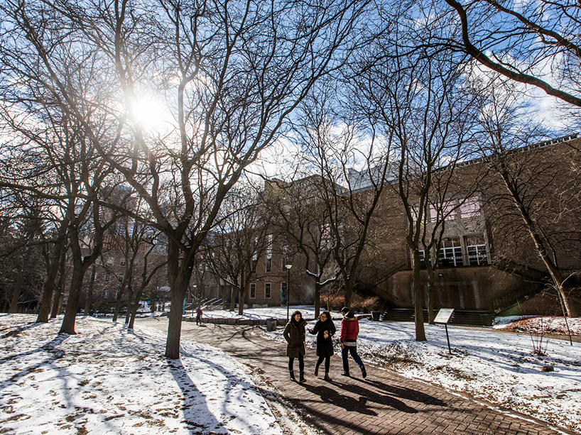 Students walk through TMU quad in winter