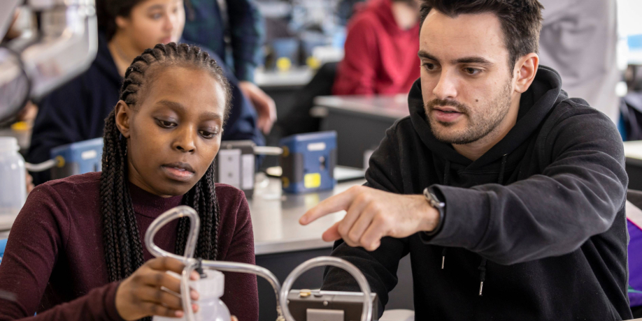 Two occupational health and safety students perform experiments in the lab.