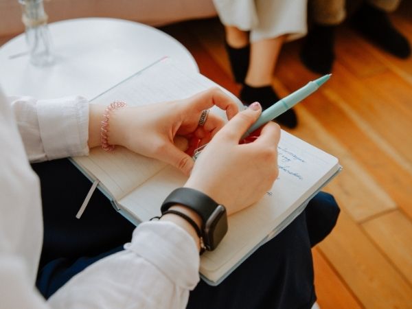 Person writing in notebook