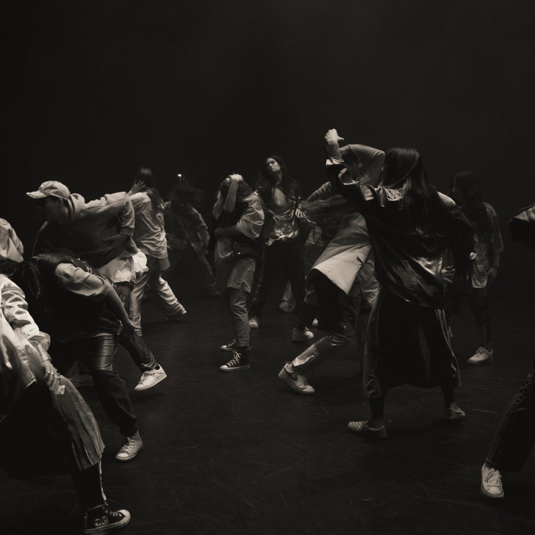black and white photo of a group of dancers jumping in sequence