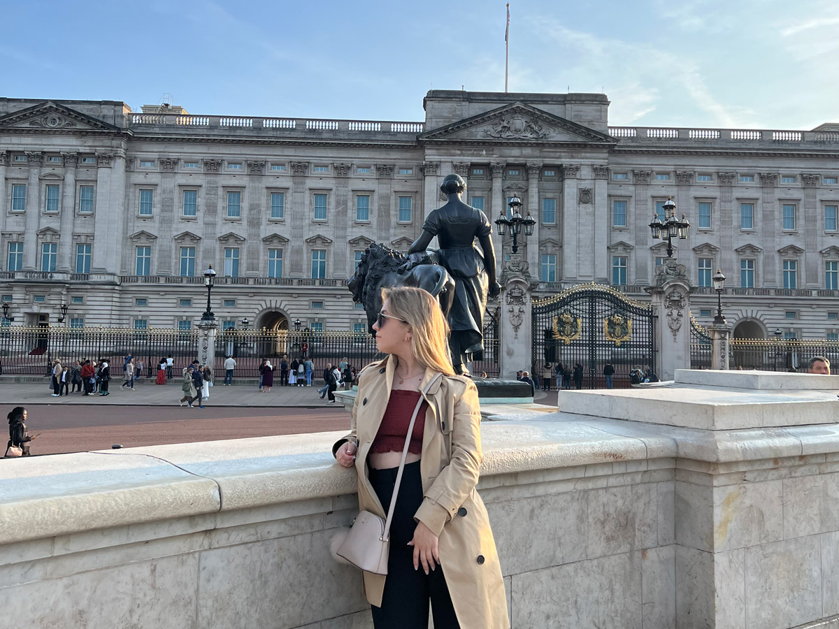 Elizabeth Velychko looks out over a busy street in London, England on a sunny day.