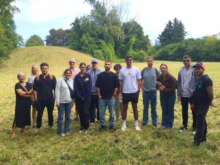 Urban and Regional Planning student team stand together on the development site for their plans in Scarborough.