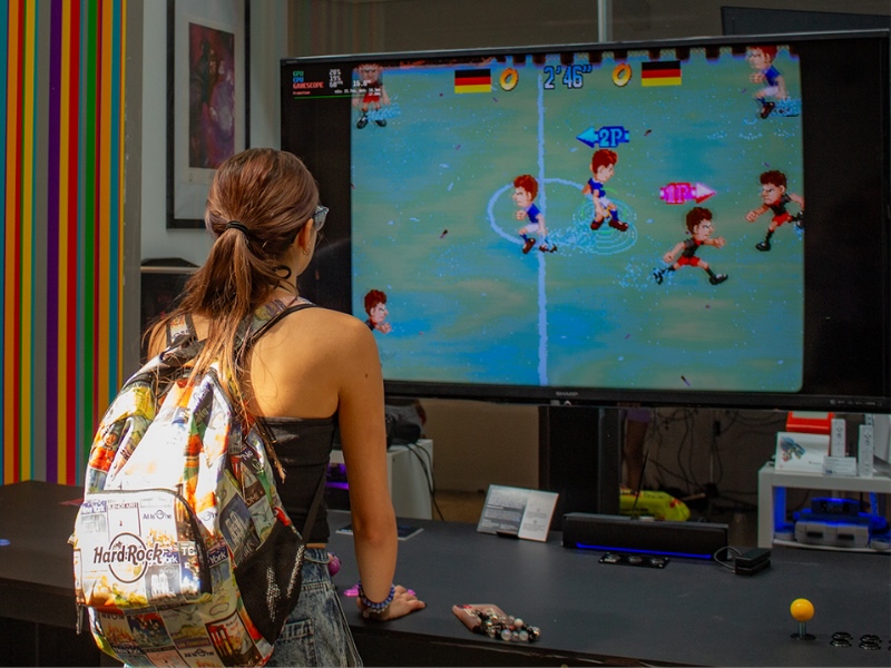 Student standing in front of the 11-foot arcade table.