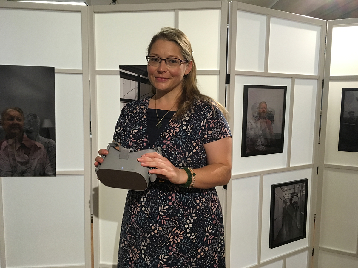 Dr. Kristine Newman poses here with a pair of goggles used to show visitors the 360Â° videos