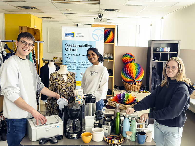 Students displaying available items at a Free Store pop-up.