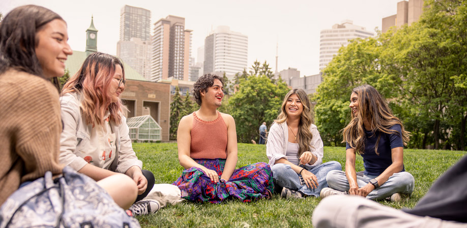 A group of students chatting in the Quad on a sunny day.