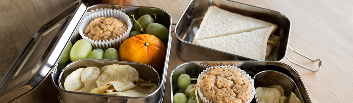 Metal lunchbox containers opened on a table top.