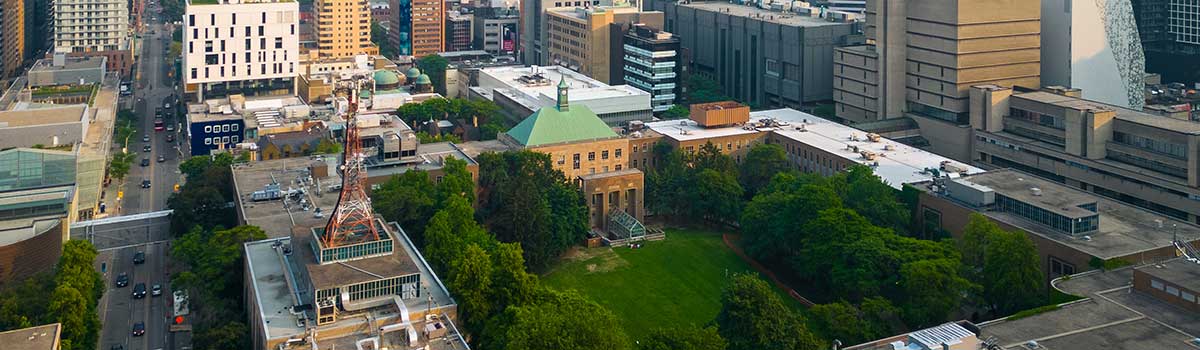 An aerial view of the TMU campus with the Kerr Hall Quad, the DCC behind it and the Toronto skyline.