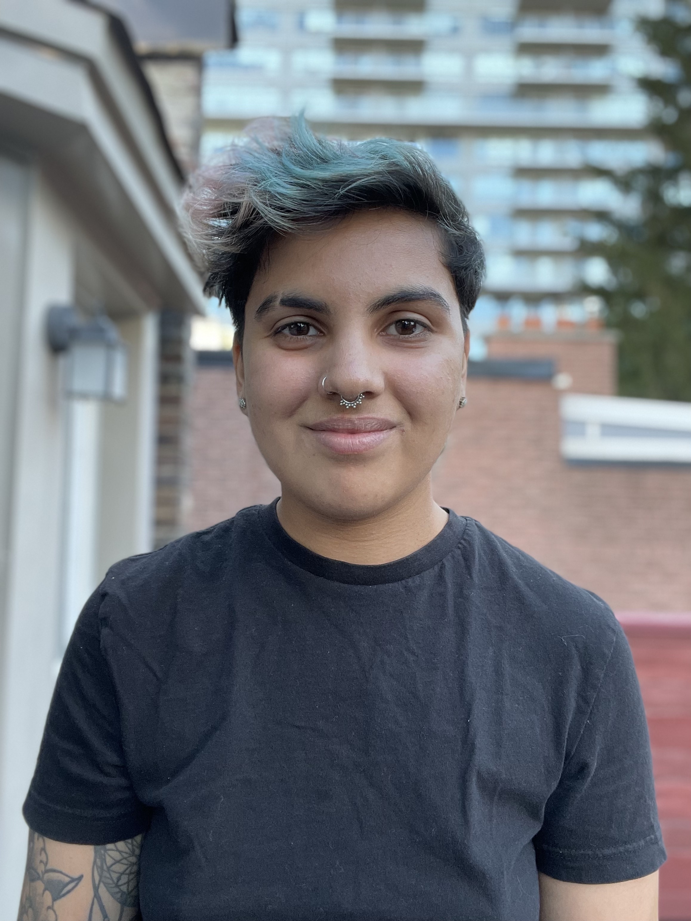 Headshot of person smiling wearing black t-shirt