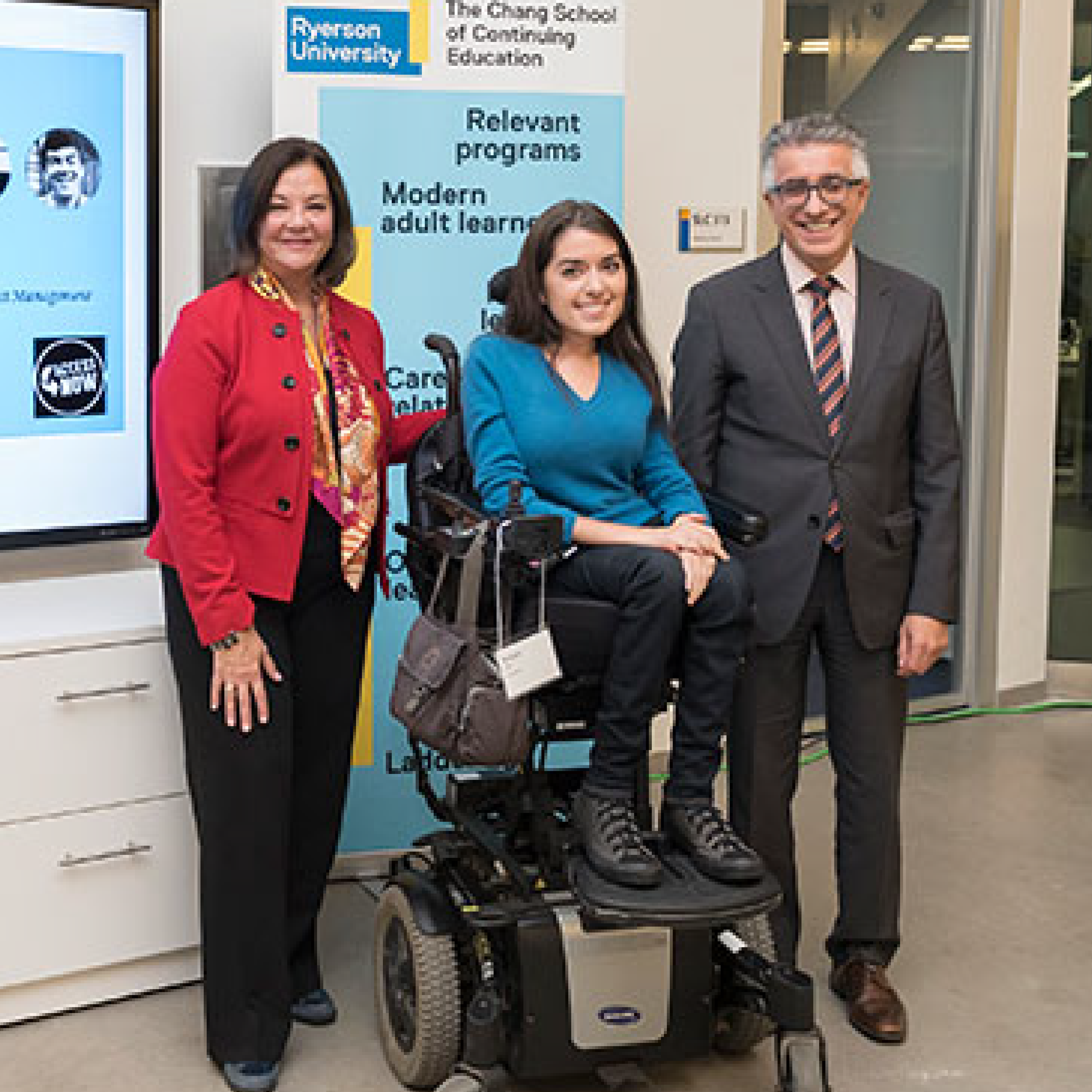 Maayan Ziv with man and woman at the Change School Accessibility Showcase