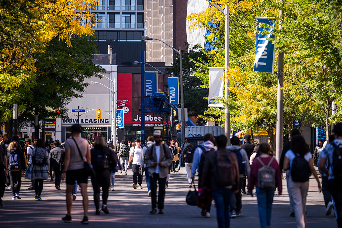 Busy Toronto street with TMU signs