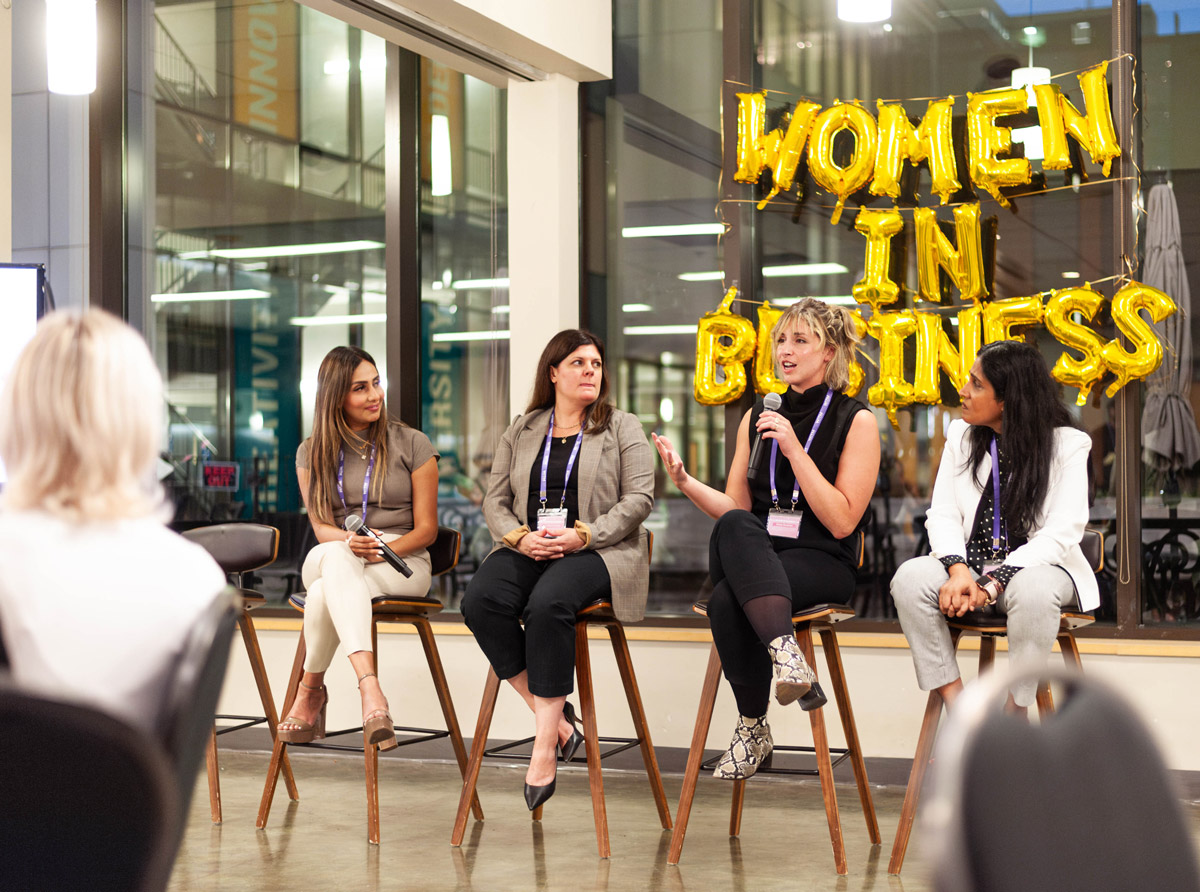 Four female speakers at a panel discussion