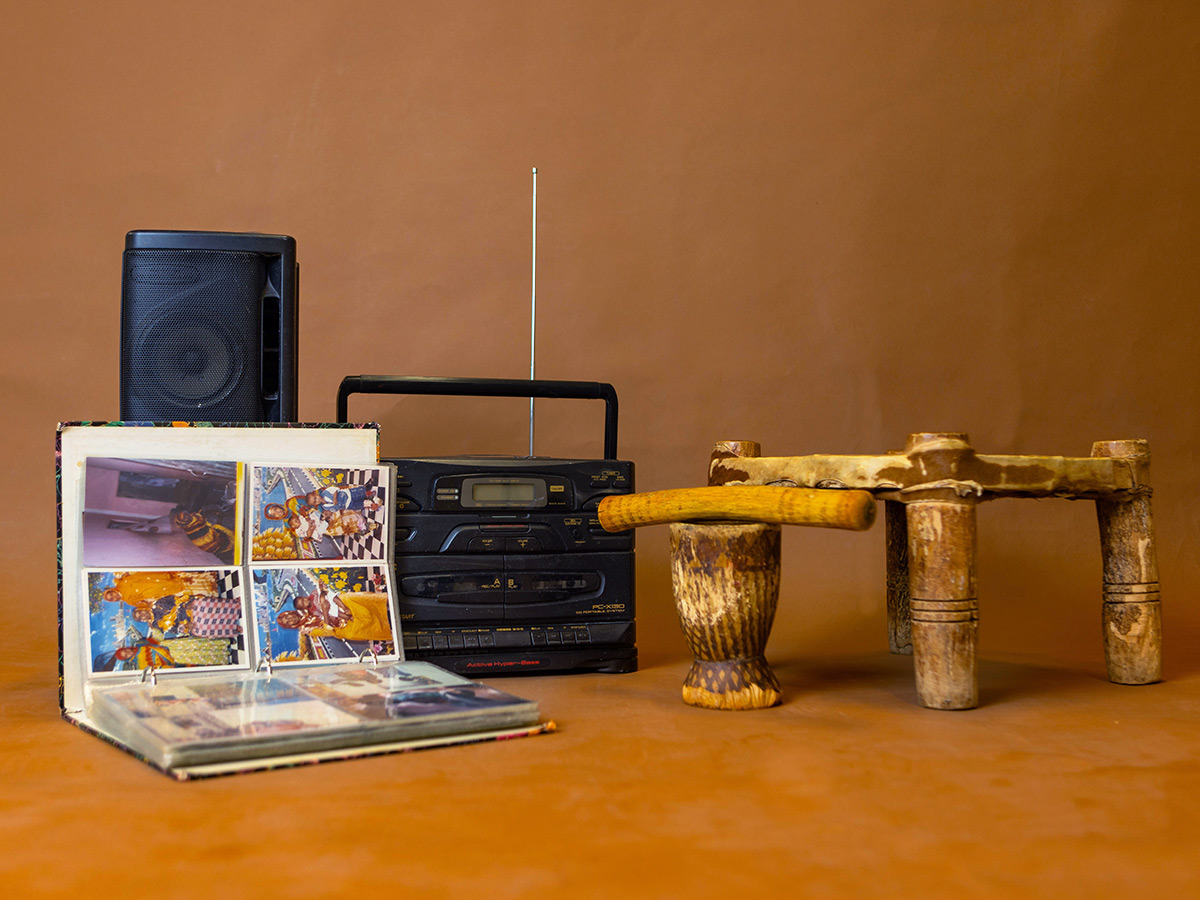 Display of juxtaposition of modern versus vintage possessions such as a wooden mortar and pestle, and a radio and speaker