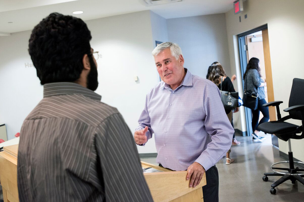 Dale Carl talking to a student right after class