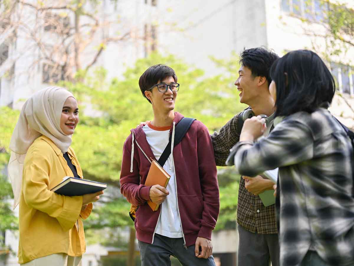 A group of happy young college students talking