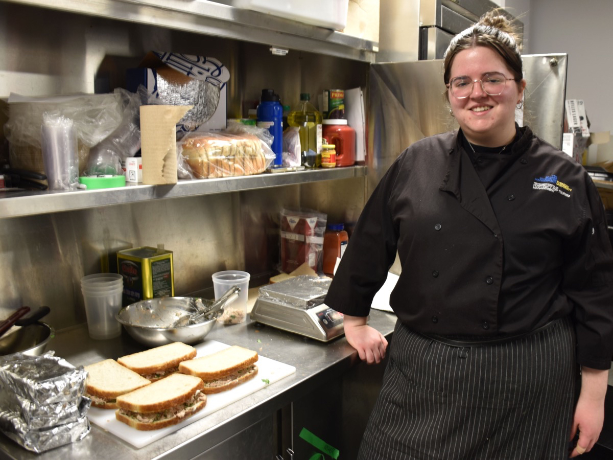 Student Kinneret Witty prepares kosher tuna sandwiches for sale