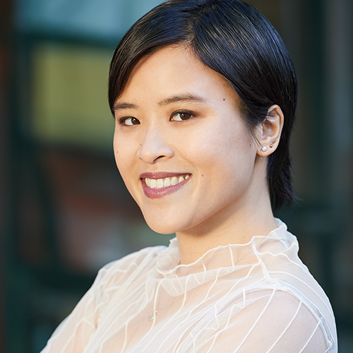 Anita Li wearing a white shirt looking into the camera