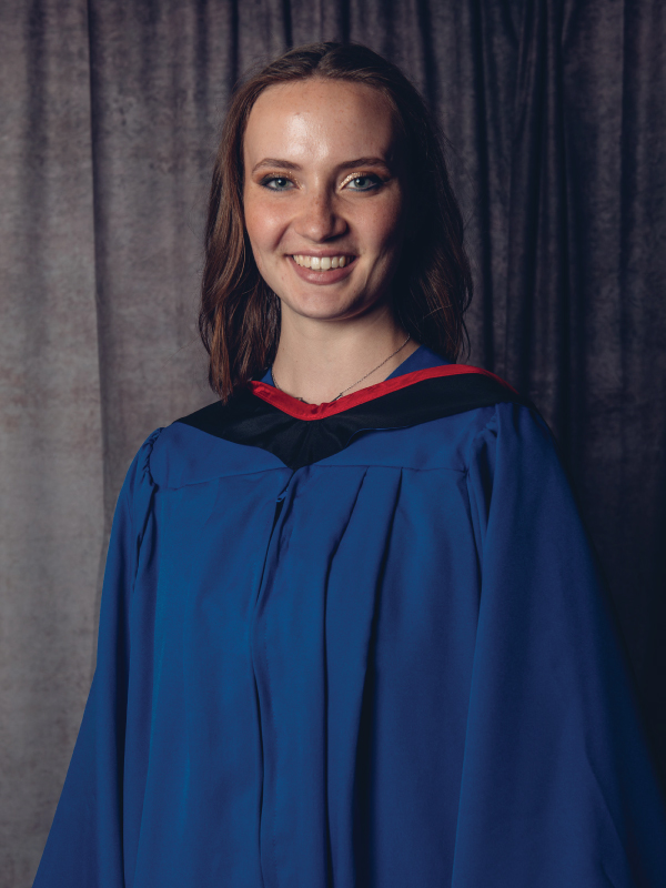 Smiling portrait of award recipient Allison MacKenzie in a blue graduation gown 