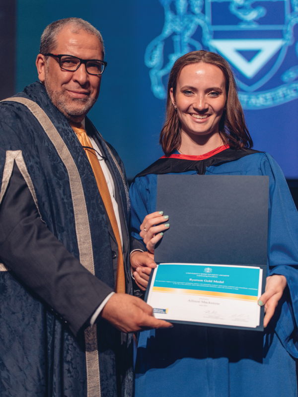 Award recipient Allison MacKenzie smiles for a picture with university president Mohamed Lachemi