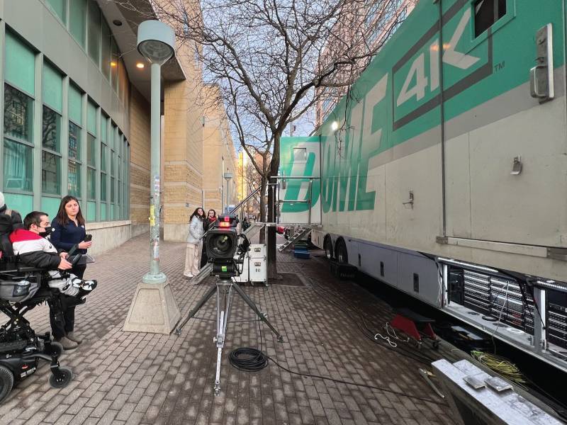 Students standing outside of the Dome mobile production truck