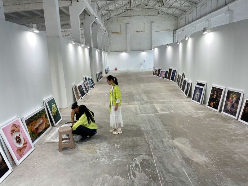 The interior of the exhibition hall with the works of art being prepared to be hung and displayed.