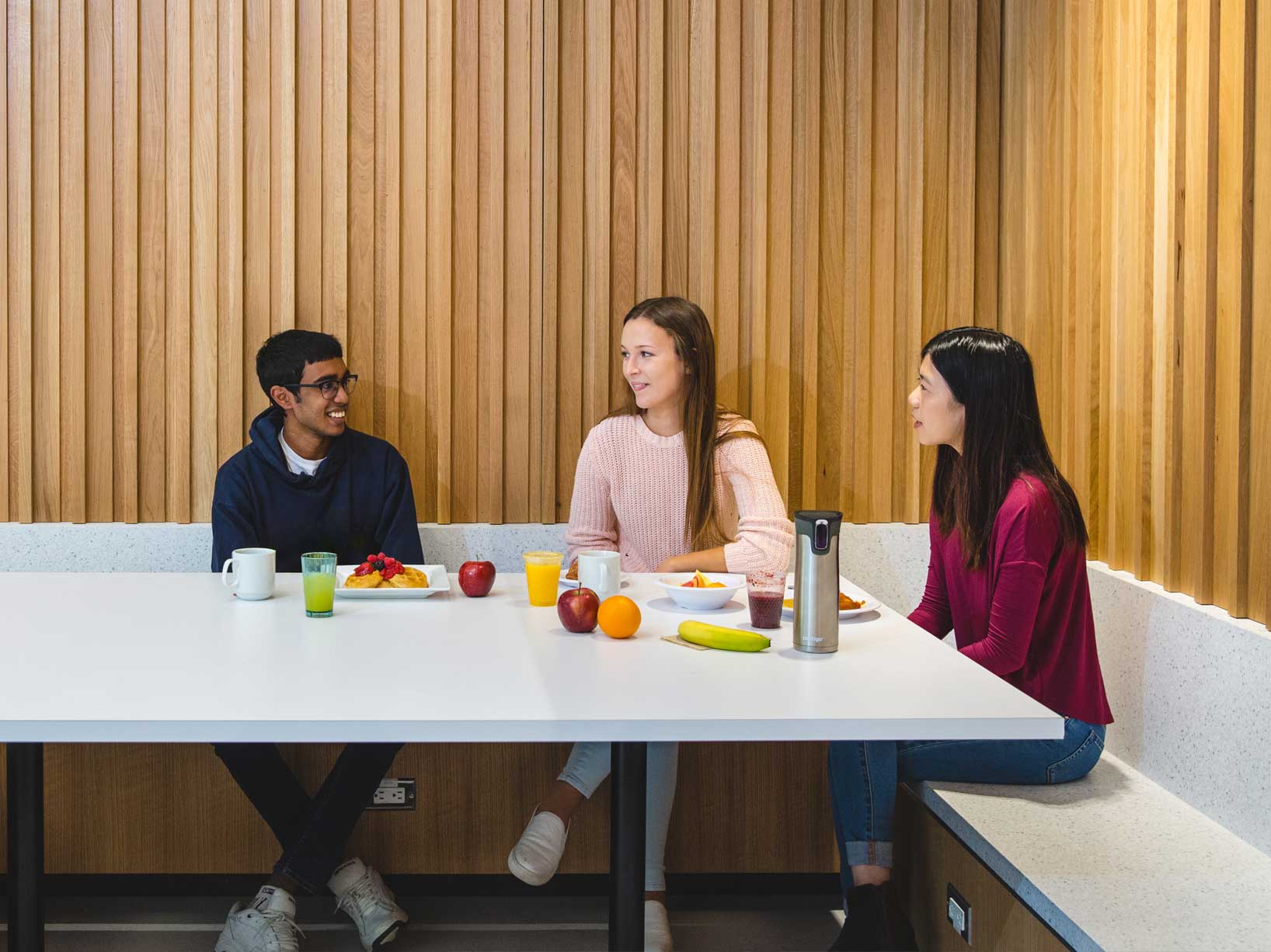 Students chatting and eating in a TMU Eats dining hall